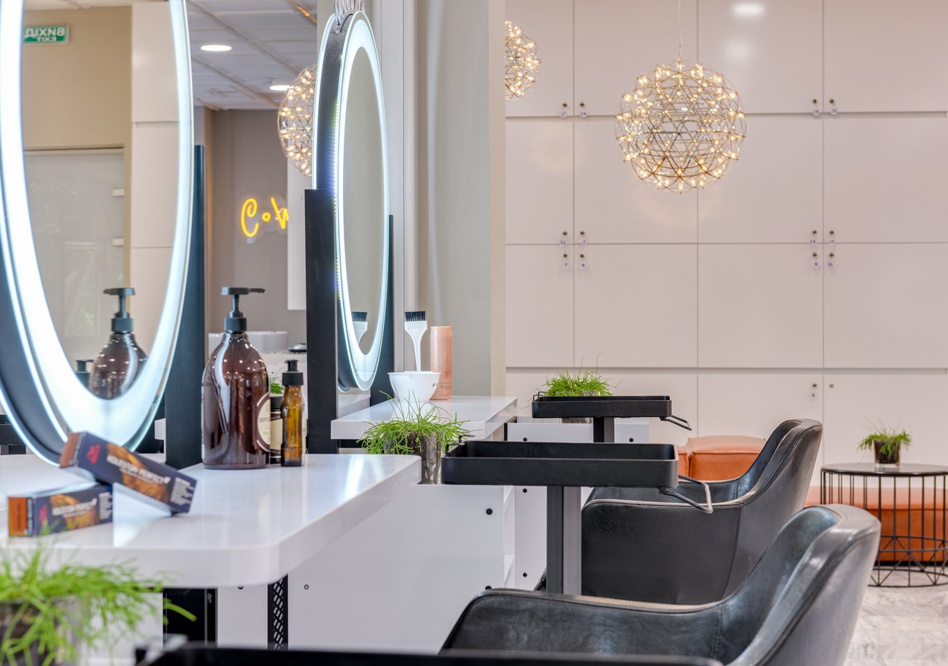 Black Seats and Round Vanity Mirrors in a Beauty Salon